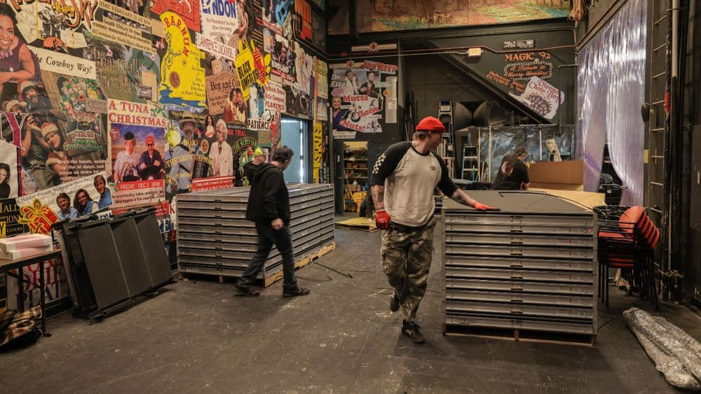 OnPoint crew moving stacked staging decks backstage