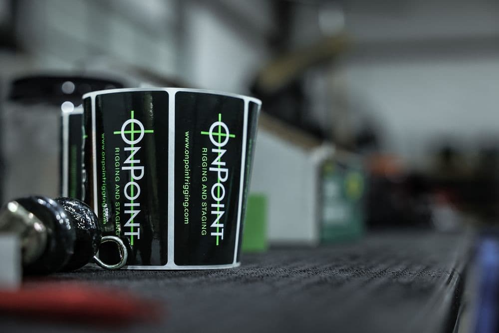 OnPoint branded gaff tape and rigging hardware on a work surface