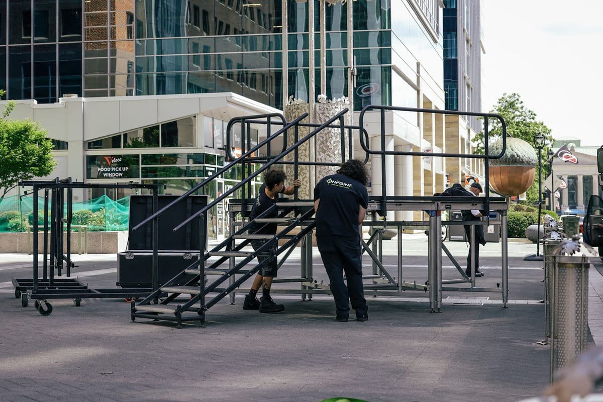 OnPoint crew assembling an outdoor stage and stair unit