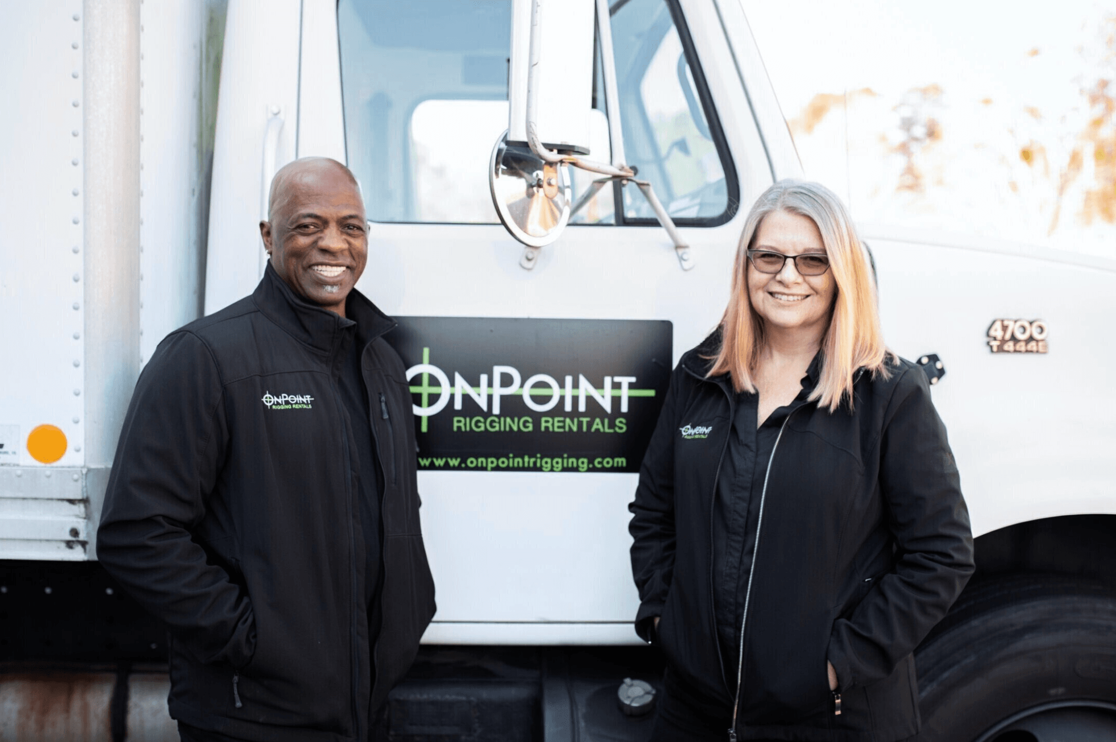 James and Caroline Bell in front of an OnPoint Rigging Rentals truck
