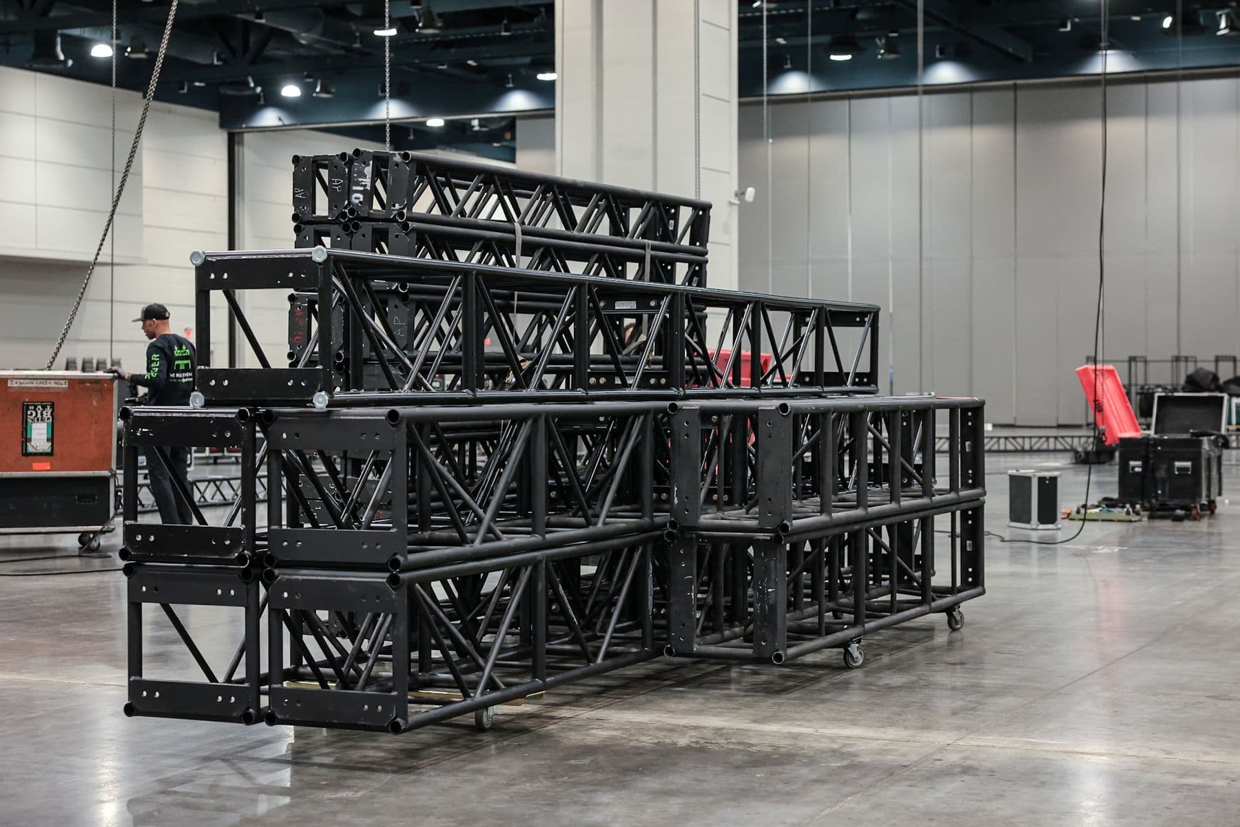Stacked truss and an OnPoint crew member on a convention hall floor before a build